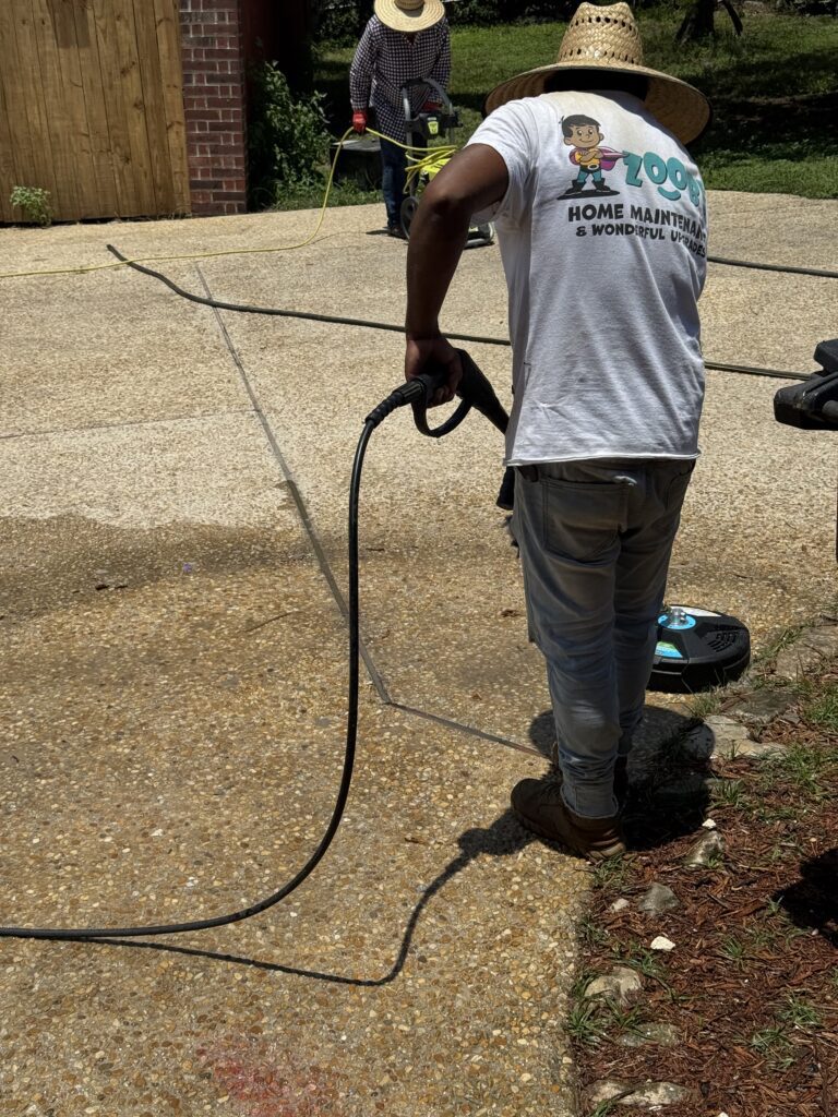 Zooby technician power washing a concrete driveway in San Antonio