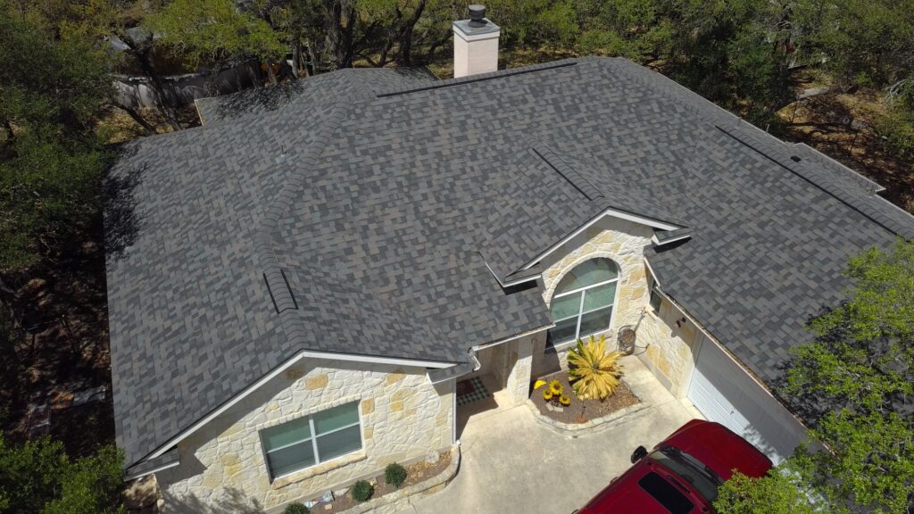 New Zooby shingle roof on a stone home with an arched window